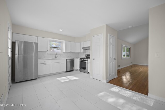 12 Mayfair Rd, Holmdel, NJ 07733 - kitchen with light countertops, plenty of natural light, stainless steel appliances, and under cabinet range hood