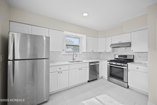12 Mayfair Rd, Holmdel, NJ 07733 - kitchen featuring decorative backsplash, a sink, stainless steel appliances, light countertops, and under cabinet range hood