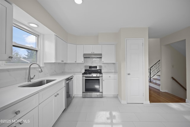 12 Mayfair Rd, Holmdel, NJ 07733 - kitchen with tasteful backsplash, a sink, stainless steel appliances, light countertops, and under cabinet range hood