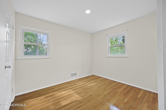 12 Mayfair Rd, Holmdel, NJ 07733 - empty room with baseboards, visible vents, a healthy amount of sunlight, and light wood-style floors