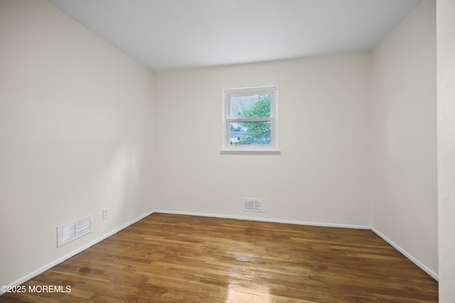 12 Mayfair Rd, Holmdel, NJ 07733 - unfurnished room with baseboards, visible vents, and wood finished floors