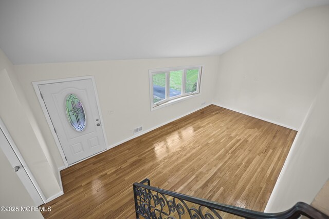 12 Mayfair Rd, Holmdel, NJ 07733 - foyer entrance with baseboards, visible vents, wood finished floors, and vaulted ceiling