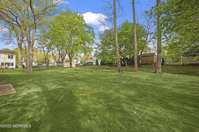 12 Mayfair Rd, Holmdel, NJ 07733 - view of yard featuring fence and a trampoline