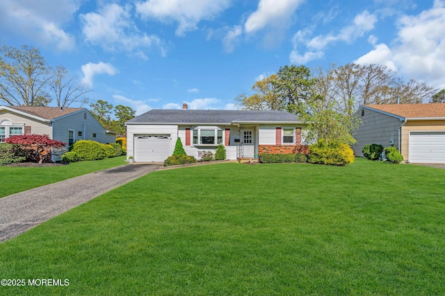 ranch-style house with a garage, a chimney, a front yard, and aphalt driveway