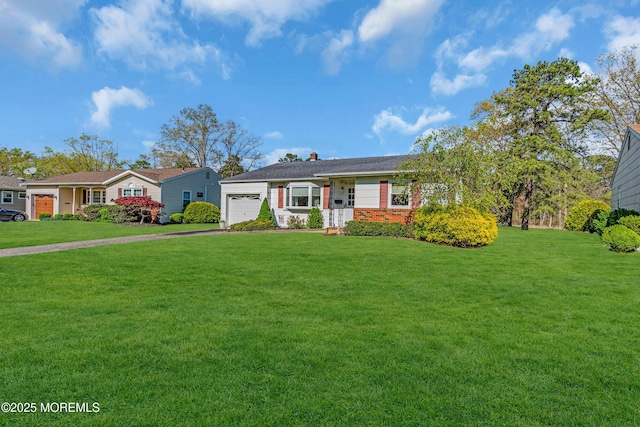 ranch-style home with an attached garage, driveway, a chimney, and a front yard