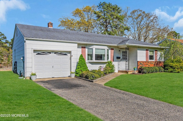 ranch-style home with brick siding, a garage, aphalt driveway, a front yard, and a chimney
