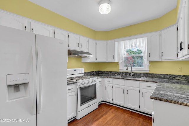 kitchen with a sink, white cabinets, under cabinet range hood, and white appliances