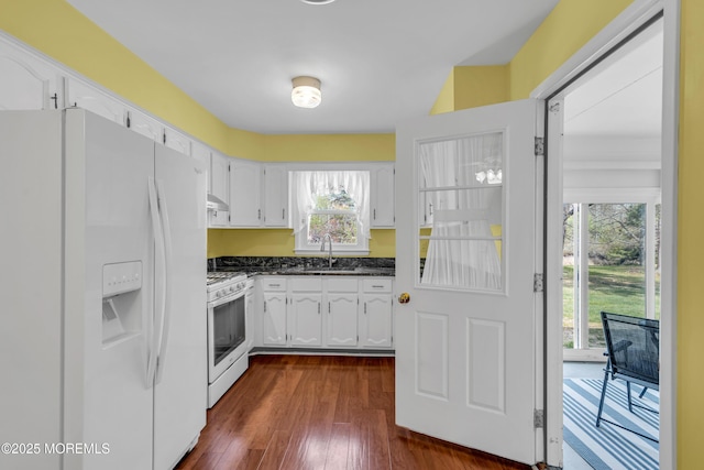 kitchen featuring dark wood-style flooring, white appliances, range hood, white cabinetry, and a sink
