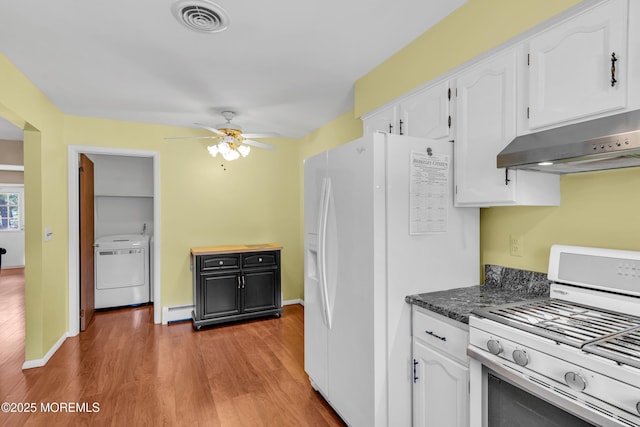 kitchen featuring gas stove, white refrigerator with ice dispenser, washer / clothes dryer, a baseboard radiator, and under cabinet range hood