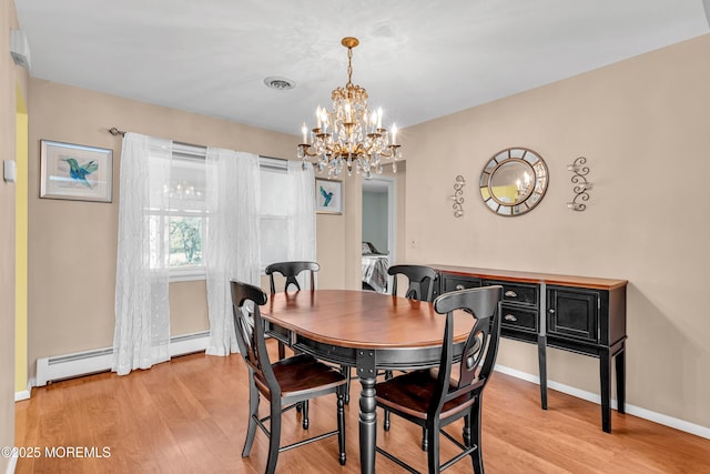 dining room with a baseboard heating unit, baseboards, a chandelier, and light wood-type flooring