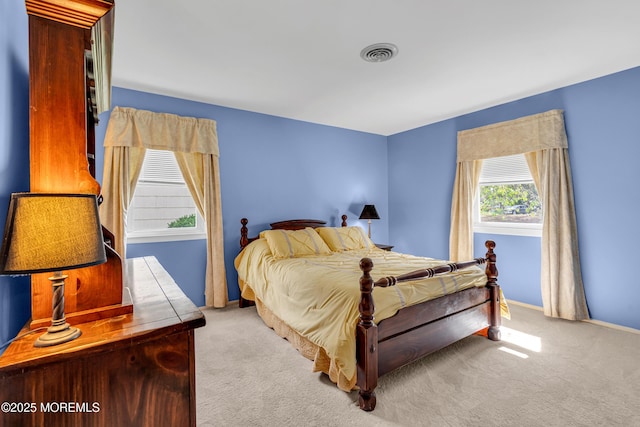 bedroom with carpet flooring, baseboards, and visible vents