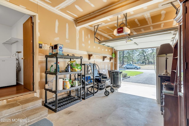 garage with washer / dryer and a garage door opener