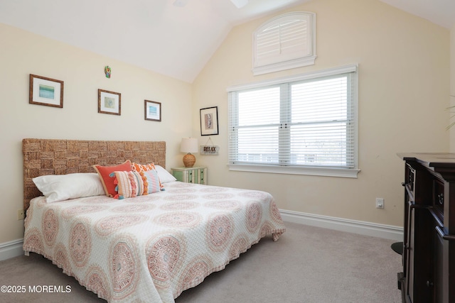 bedroom with carpet floors, baseboards, and lofted ceiling