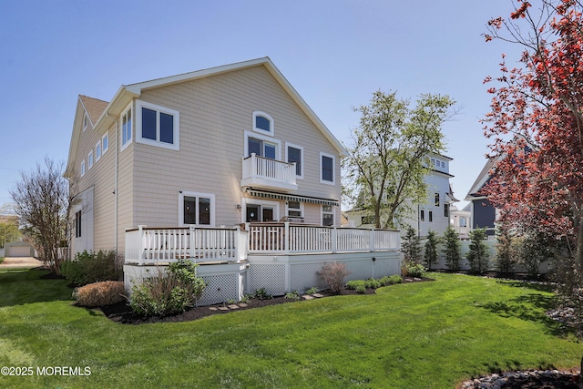 back of house featuring a yard, a deck, and a balcony