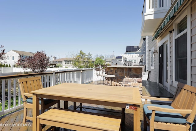 deck featuring a residential view, outdoor dining space, and outdoor dry bar