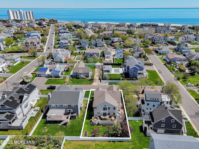 drone / aerial view with a water view and a residential view