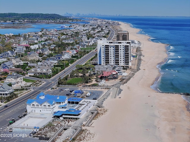 bird's eye view featuring a water view and a view of the beach