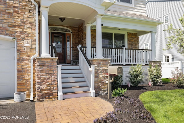 property entrance with roof with shingles, covered porch, and stone siding