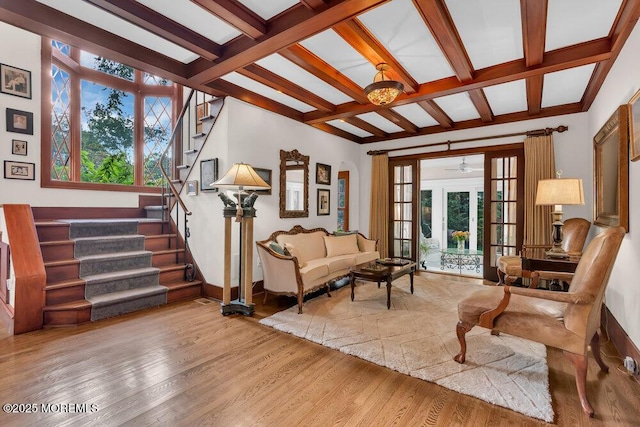 living room featuring stairway, beam ceiling, wood finished floors, baseboards, and french doors