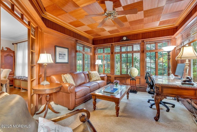 carpeted office featuring ceiling fan, wooden walls, crown molding, and wood ceiling