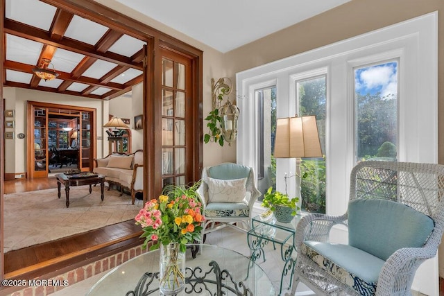 sunroom with coffered ceiling and french doors