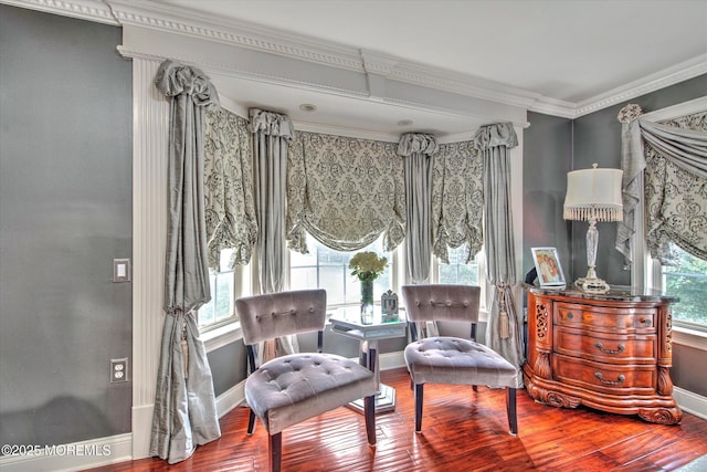 sitting room featuring crown molding, baseboards, and wood finished floors
