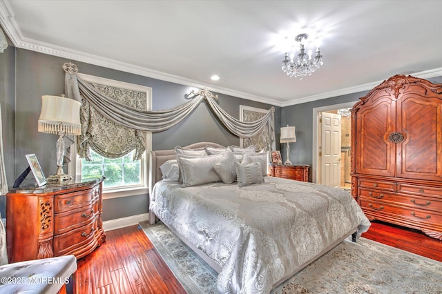 bedroom with baseboards, crown molding, hardwood / wood-style flooring, and an inviting chandelier