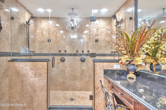 full bathroom with a shower stall and vanity