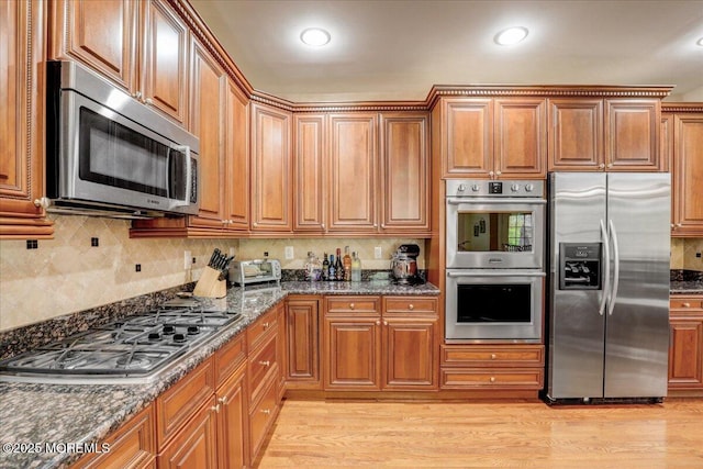 kitchen with appliances with stainless steel finishes and brown cabinets