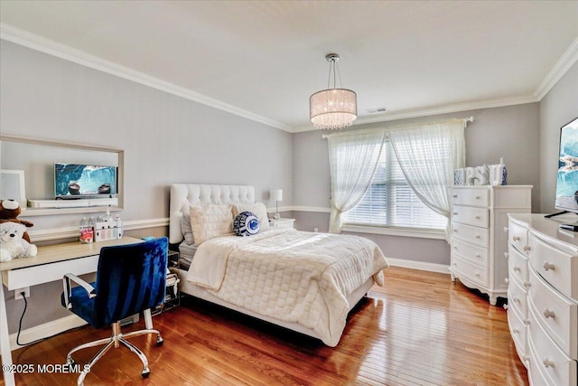 bedroom featuring crown molding, multiple windows, and wood finished floors
