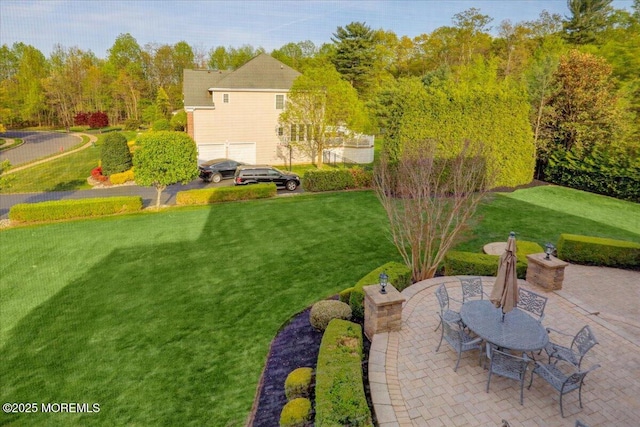 view of yard with a garage and a patio area