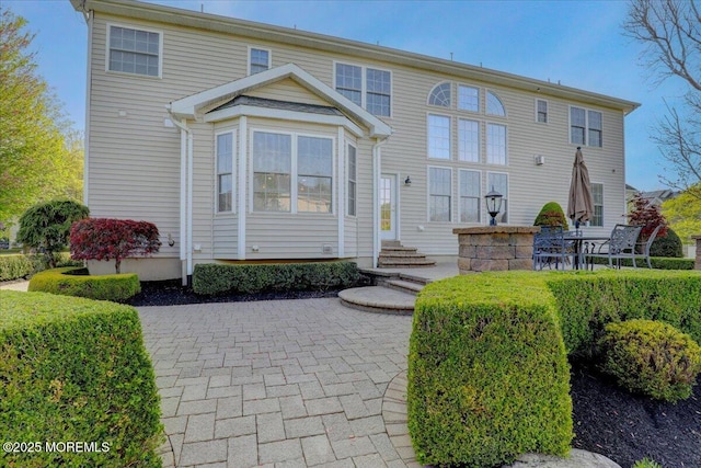 rear view of property featuring entry steps