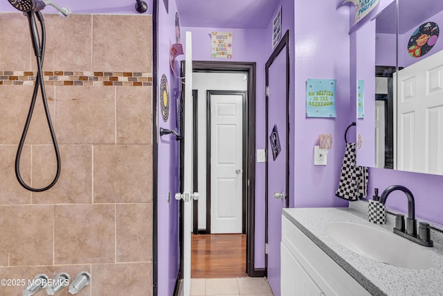 bathroom featuring a tile shower, vanity, visible vents, and tile patterned flooring