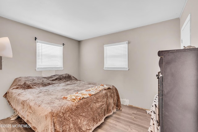 bedroom featuring light wood-style floors and multiple windows