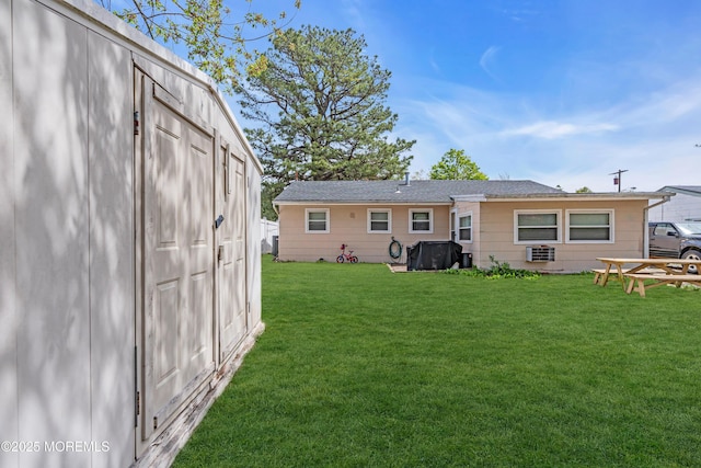 back of property featuring a yard