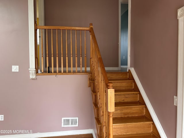 stairs with visible vents and baseboards