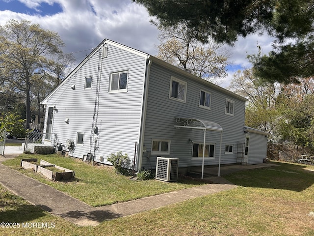 back of house featuring a patio area, a yard, and central air condition unit