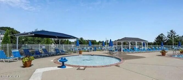 pool with a gazebo, a patio area, and fence