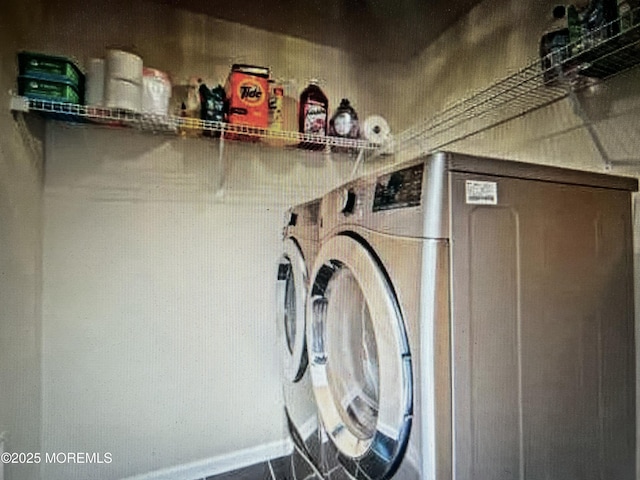washroom featuring washer and clothes dryer and laundry area