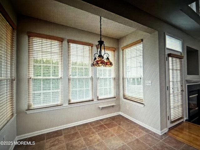 unfurnished dining area with baseboards and a wealth of natural light