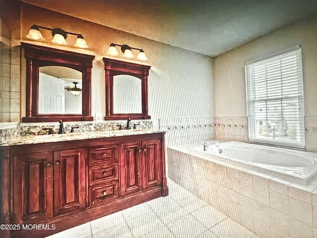 full bathroom with a bath, double vanity, and a sink