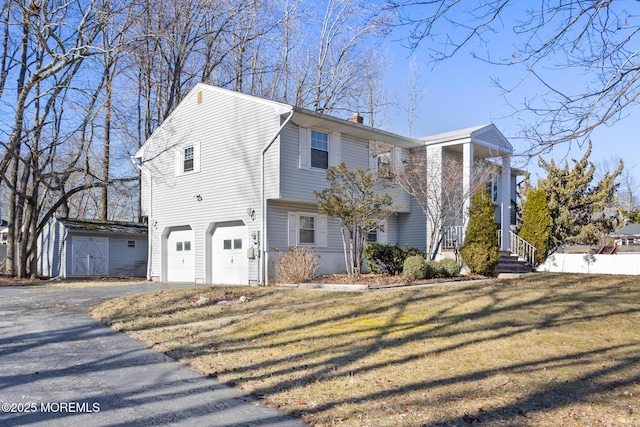 52 Yorke Ct, Freehold, NJ 07728 - view of home's exterior featuring a garage, a chimney, a yard, and driveway