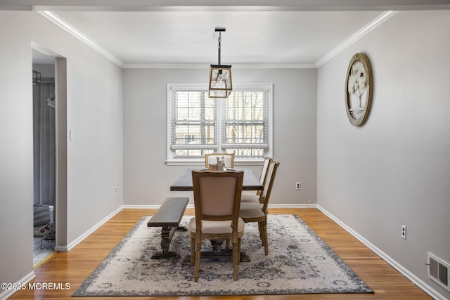 52 Yorke Ct, Freehold, NJ 07728 - dining space with crown molding, baseboards, light wood finished floors, and visible vents