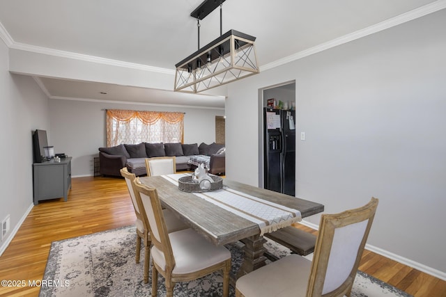 52 Yorke Ct, Freehold, NJ 07728 - dining room with crown molding, light wood-style flooring, baseboards, and visible vents