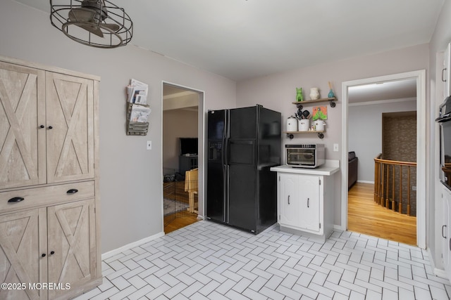 52 Yorke Ct, Freehold, NJ 07728 - kitchen with white cabinets, open shelves, light countertops, baseboards, and black fridge with ice dispenser