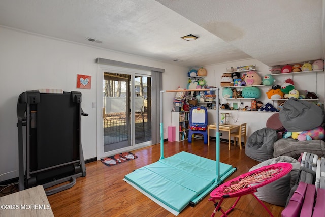 52 Yorke Ct, Freehold, NJ 07728 - game room featuring visible vents, a textured ceiling, and wood finished floors
