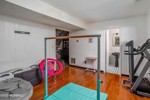 52 Yorke Ct, Freehold, NJ 07728 - exercise room featuring visible vents and hardwood / wood-style floors
