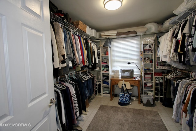 spacious closet with light tile patterned floors