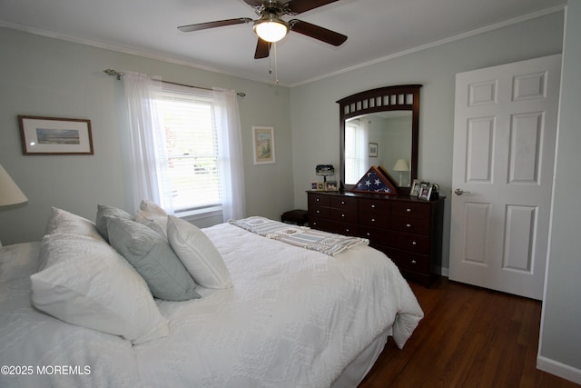 bedroom with ornamental molding, ceiling fan, and dark wood finished floors