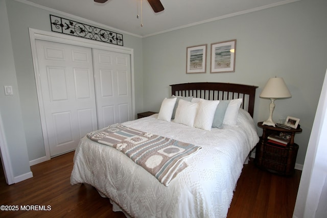 bedroom featuring a closet, ceiling fan, crown molding, baseboards, and wood finished floors
